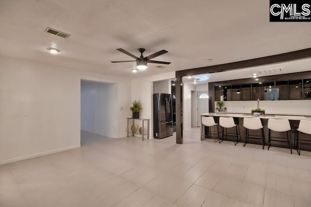 living room featuring ceiling fan and bar