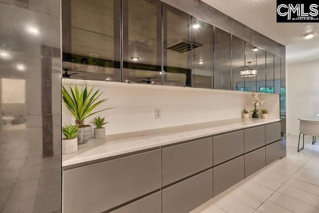 bathroom with tile patterned flooring, ceiling fan, and vanity