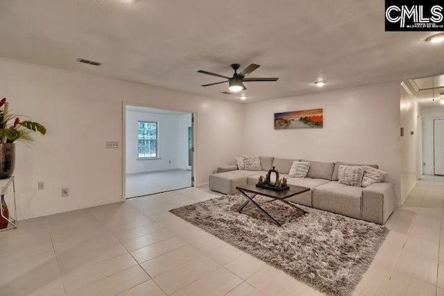 tiled living room featuring ceiling fan