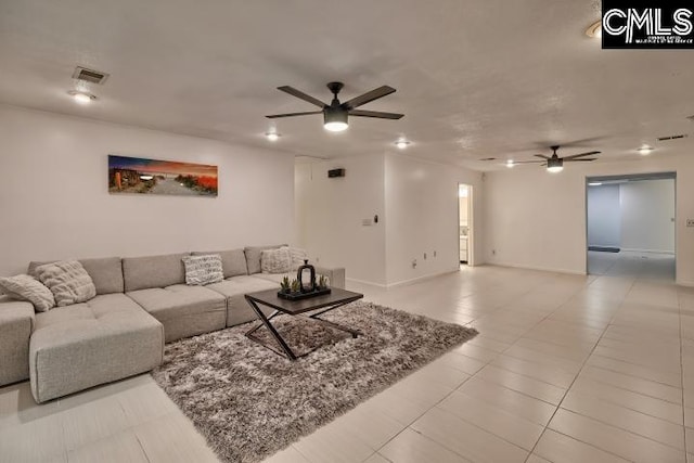 living room with ceiling fan and light tile patterned floors