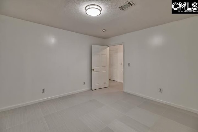 spare room featuring a textured ceiling