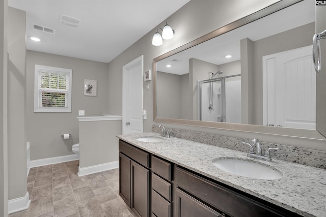 bathroom with vanity, toilet, and an enclosed shower