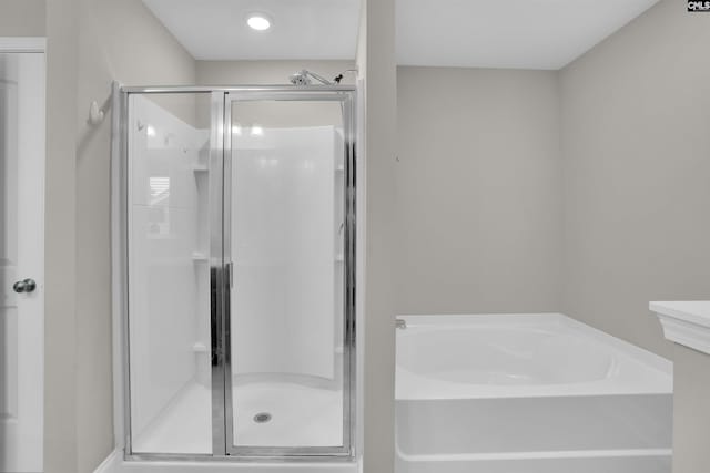 bathroom with separate shower and tub