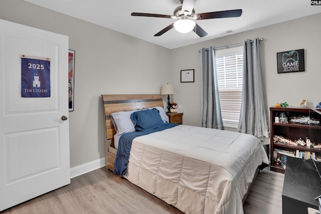 bedroom with ceiling fan and light hardwood / wood-style flooring