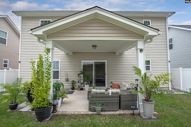 back of property featuring a lawn and a patio