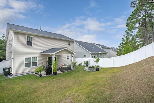 rear view of property featuring a yard and a patio area