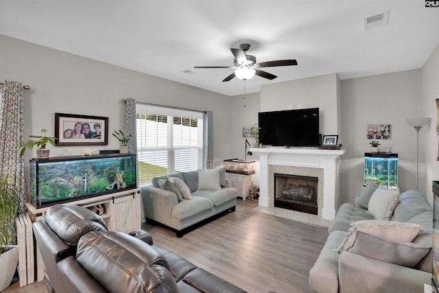 living room with ceiling fan and hardwood / wood-style floors