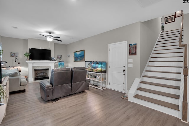 living room with ceiling fan and light hardwood / wood-style floors