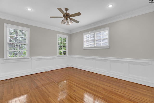 spare room with ceiling fan, hardwood / wood-style flooring, and ornamental molding