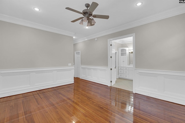 unfurnished room featuring ceiling fan, crown molding, and light hardwood / wood-style floors