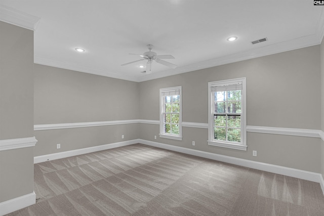 carpeted spare room with ceiling fan and crown molding