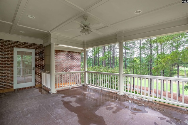 unfurnished sunroom with coffered ceiling and ceiling fan