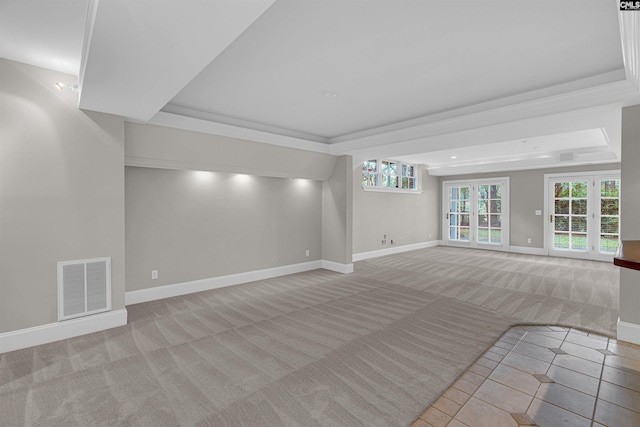 unfurnished living room with a raised ceiling and light colored carpet