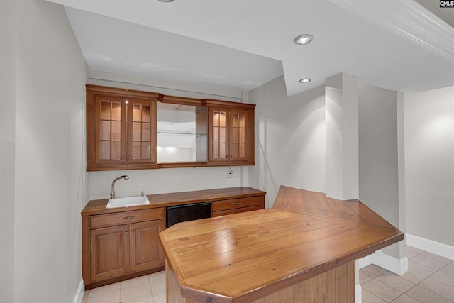 tiled home office featuring sink