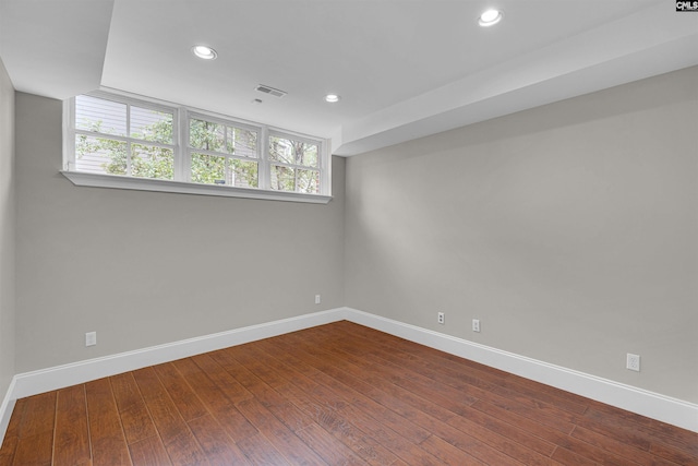 empty room featuring a healthy amount of sunlight and wood-type flooring