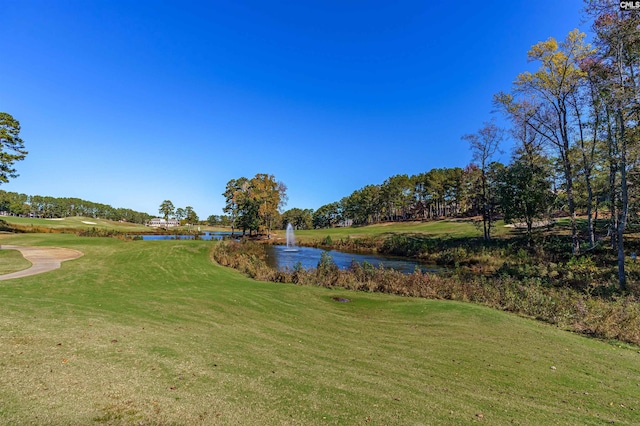 surrounding community featuring a yard and a water view