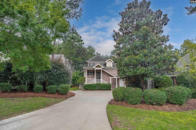 obstructed view of property featuring a front yard and a porch