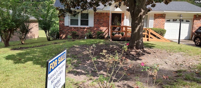 single story home with a front yard and a garage