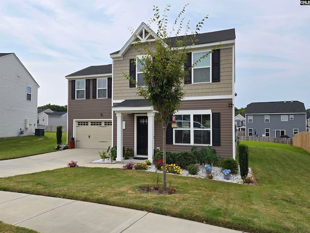 craftsman inspired home featuring a garage, fence, a front lawn, and concrete driveway