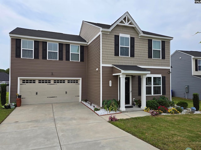 craftsman house with a front yard, driveway, and an attached garage