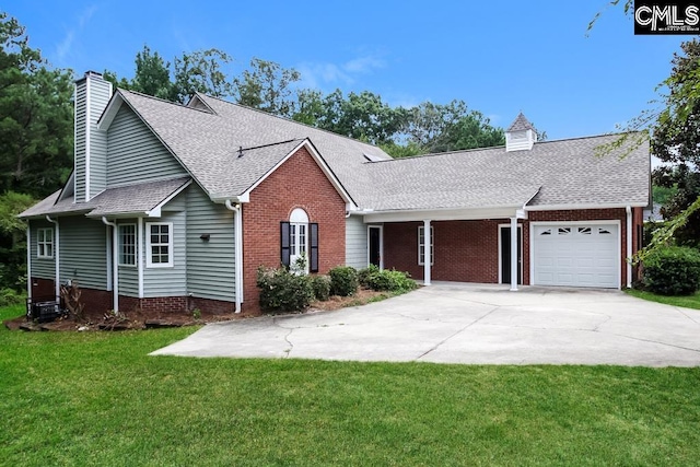 view of front of house with a garage and a front lawn