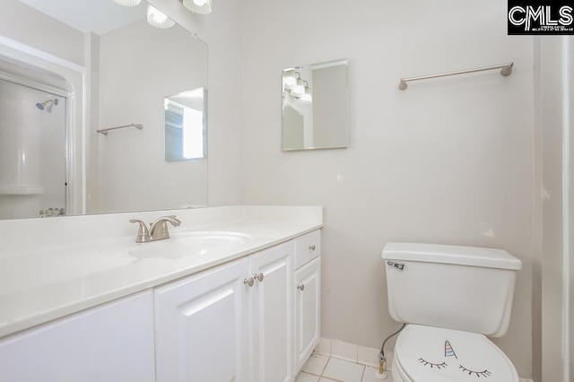 bathroom featuring vanity, toilet, and tile patterned floors