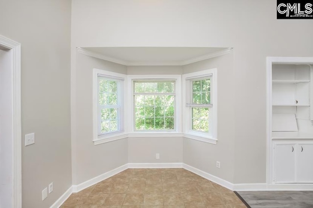 interior space featuring light tile patterned flooring and crown molding