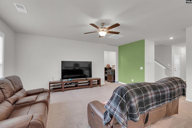 carpeted living room with ceiling fan