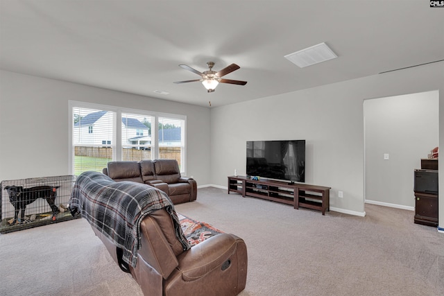 carpeted living room with ceiling fan