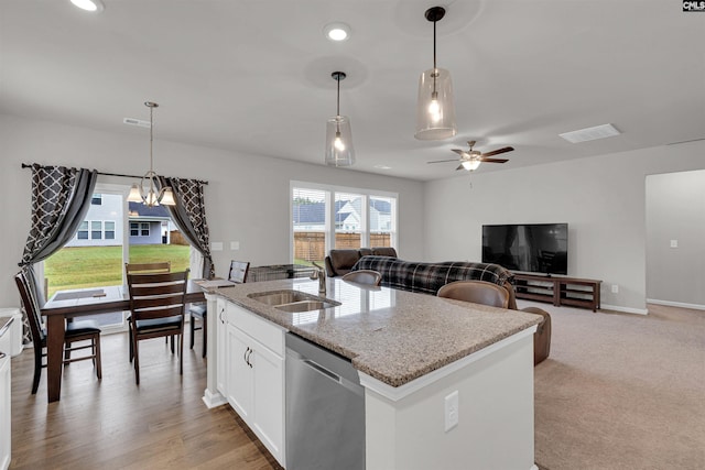 kitchen with a center island with sink, dishwasher, sink, and white cabinets