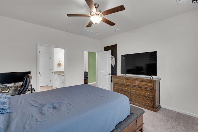 carpeted bedroom with ceiling fan and ensuite bathroom