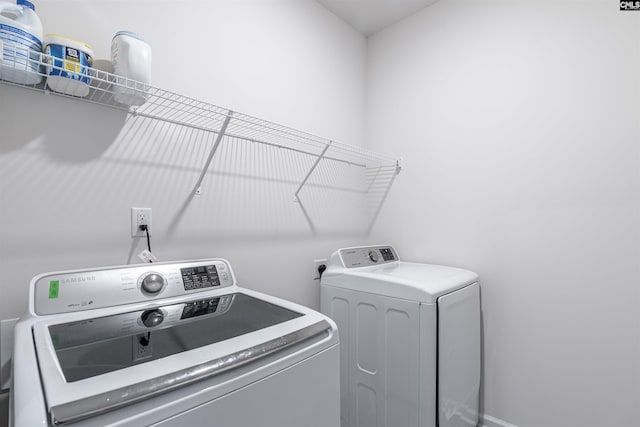 clothes washing area featuring washing machine and clothes dryer