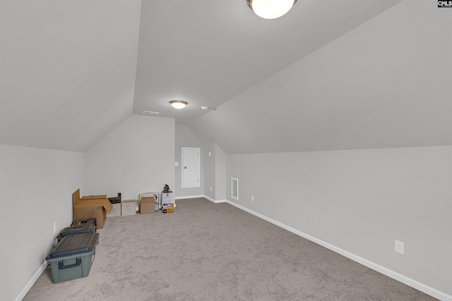 bonus room with carpet floors and lofted ceiling