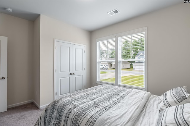 bedroom with a closet and carpet flooring