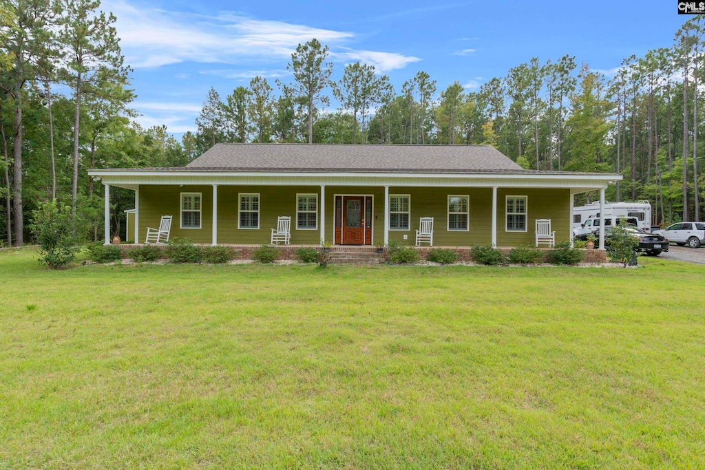 view of front of house with a front yard and covered porch