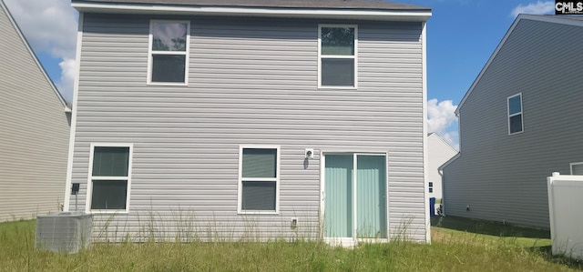 rear view of house with central air condition unit