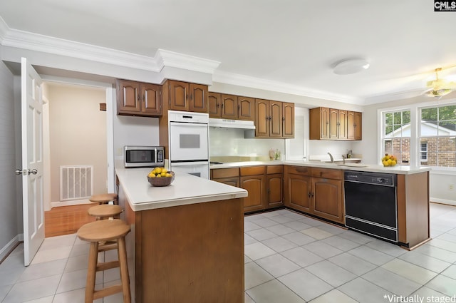 kitchen with double oven, light tile patterned flooring, ornamental molding, and dishwasher