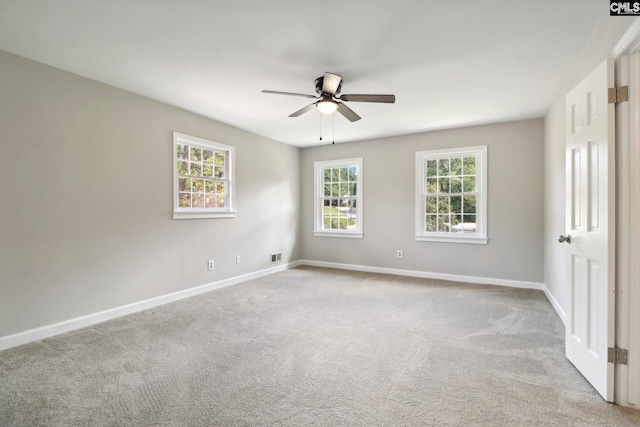 spare room with light carpet, ceiling fan, and plenty of natural light