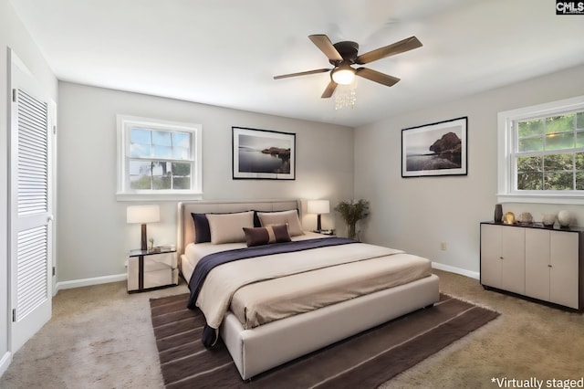 carpeted bedroom featuring a closet and ceiling fan