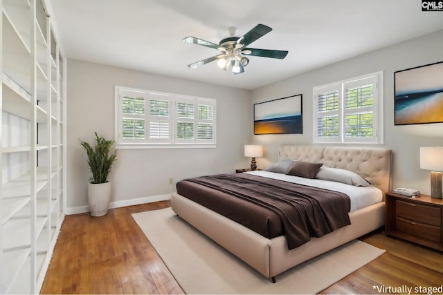 bedroom with hardwood / wood-style floors and ceiling fan