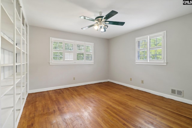 spare room with ceiling fan and hardwood / wood-style flooring