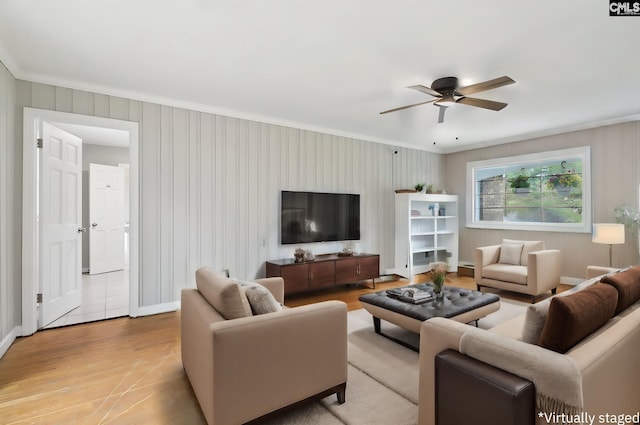 living room with crown molding, light hardwood / wood-style floors, and ceiling fan