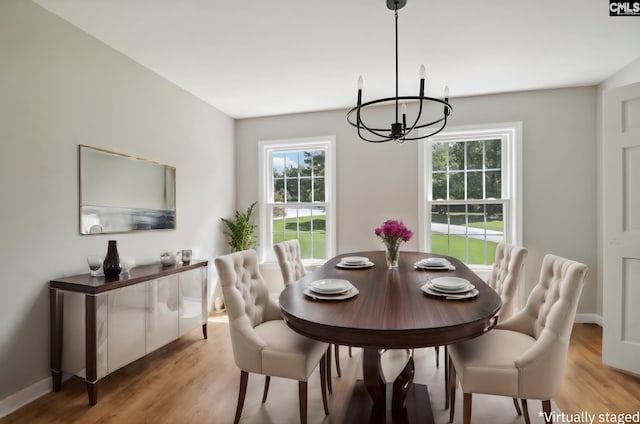 dining space featuring an inviting chandelier and light hardwood / wood-style floors