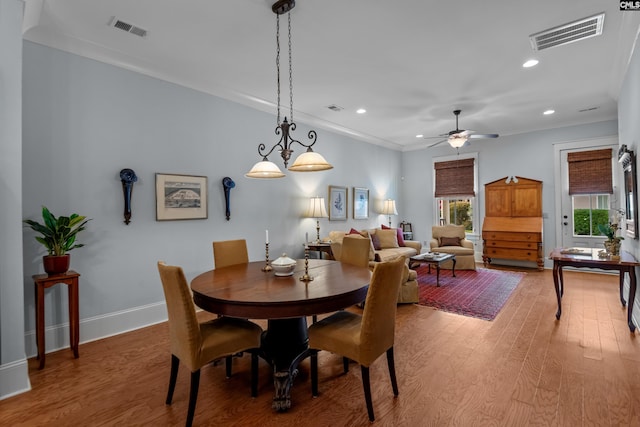 dining area with ceiling fan, hardwood / wood-style flooring, and crown molding