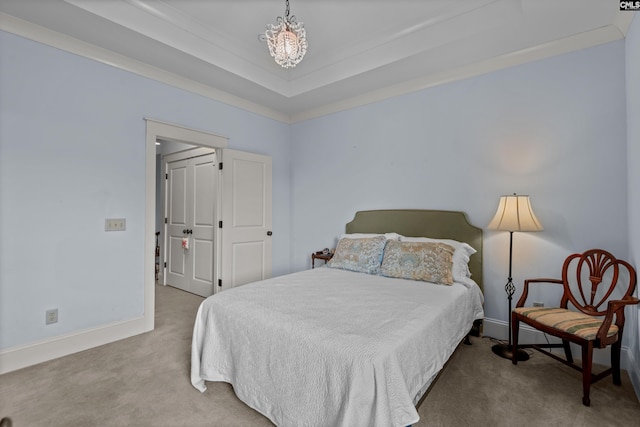 bedroom with ornamental molding, carpet, and a raised ceiling