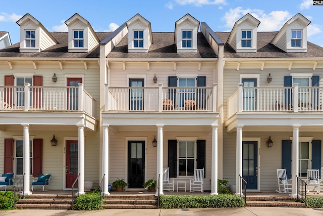 view of front of property featuring a balcony and a porch