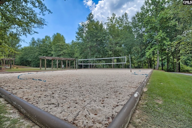 view of property's community with a pergola, volleyball court, and a yard