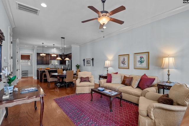 living room featuring ornamental molding, dark hardwood / wood-style floors, and ceiling fan