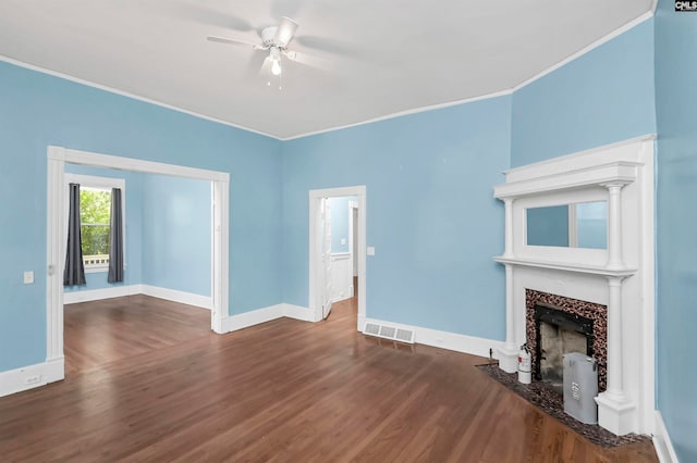 unfurnished living room featuring crown molding, dark hardwood / wood-style floors, and ceiling fan