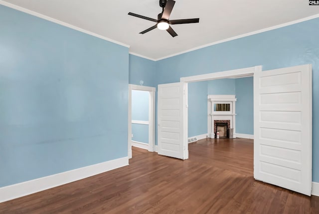 spare room with ceiling fan, crown molding, and dark hardwood / wood-style flooring